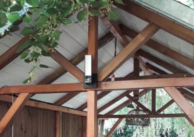 Caméra de vidéosurveillance extérieure connectée Netatmo installée sur mur pour détection de personnes et alertes.